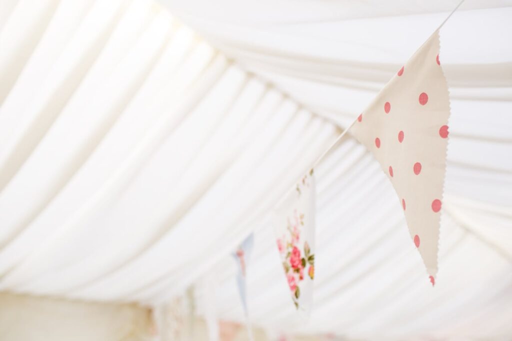 Elegant floral and polka dot bunting creates a festive atmosphere in a delicate indoor setting.