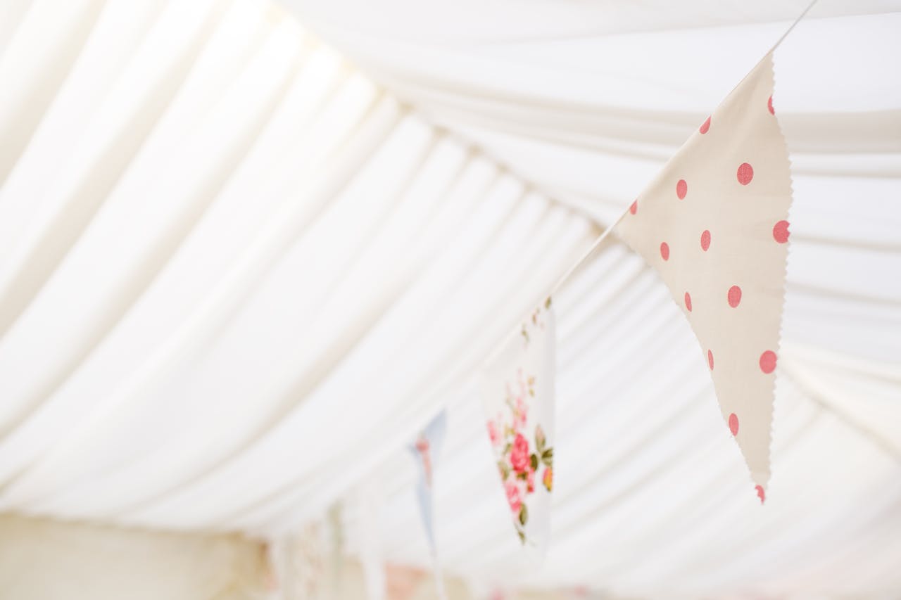 Elegant floral and polka dot bunting creates a festive atmosphere in a delicate indoor setting.